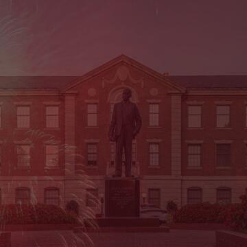 Image showing Dr. Shepard statue and administration building in the background with fireworks