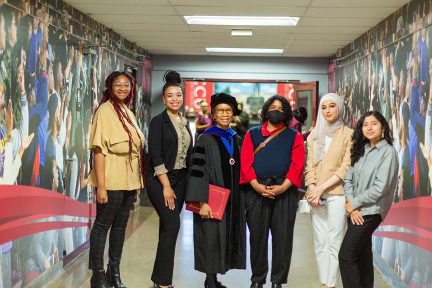 Art and Design faculty posing for a graduation photo