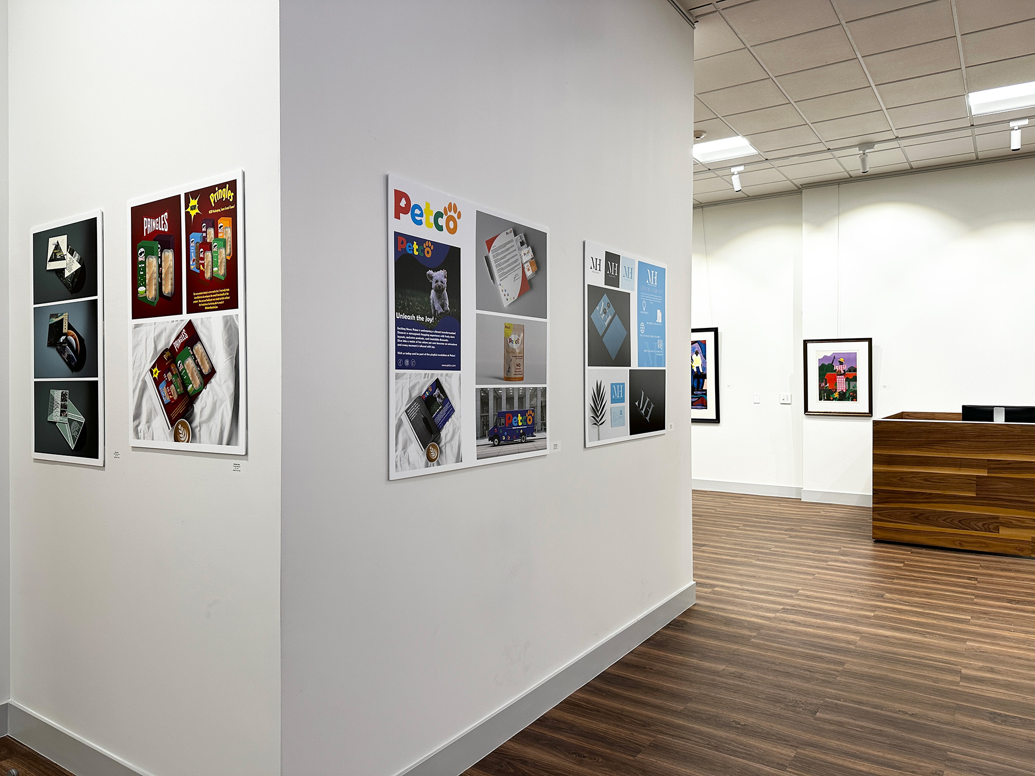 A photo of the Arts building hallway with several art pieces hung on the walls