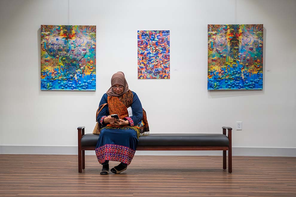 A person sitting in the NCCU art gallery