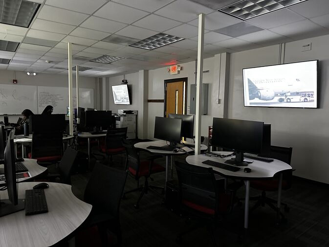 A mostly empty classroom with PCs