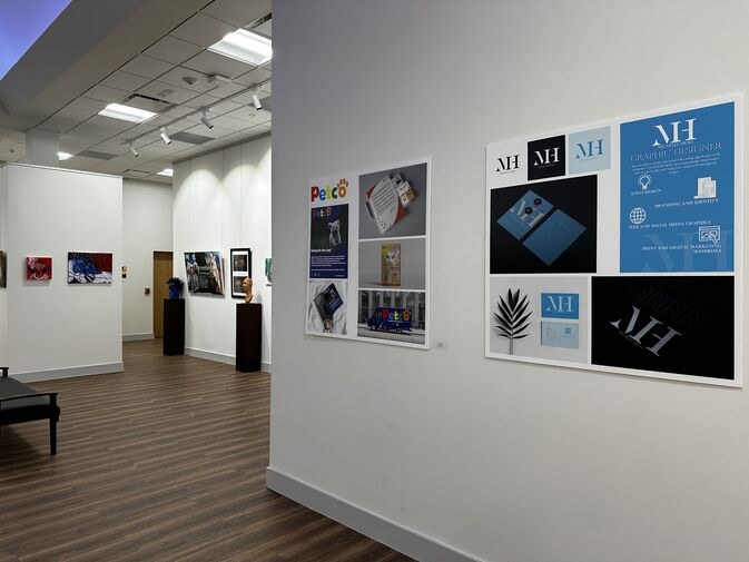 A picture of several graphic design art pieces in a gallery