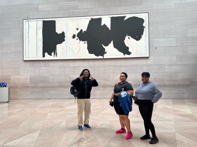 Three students enjoying an art gallery