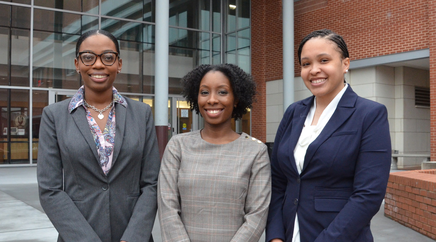 Image of law students in front of a building.