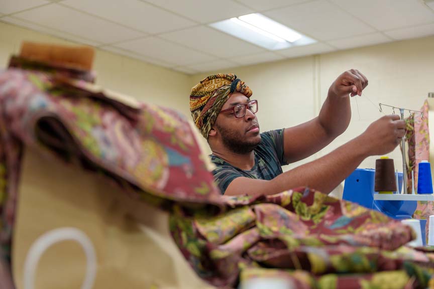 A student preparing to sew a garment