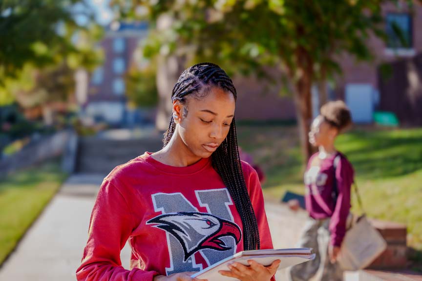 a student in NCCU apparel reading notes