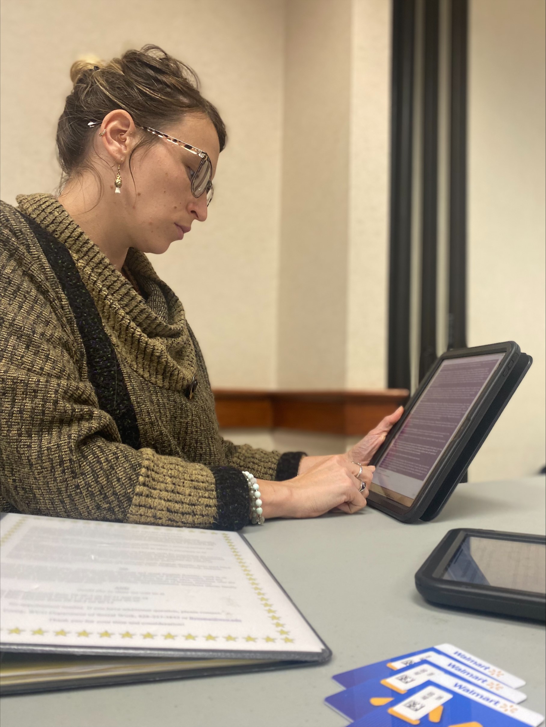 Woman sitting and working on tablet