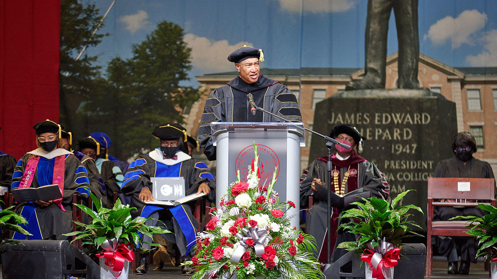 Person on the podium, presenting at the Founder's Day Convocation