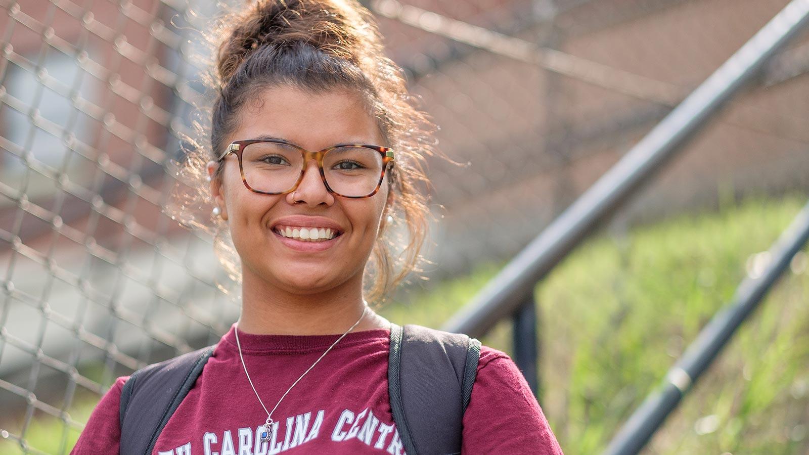NCCU student with glasses, smiling
