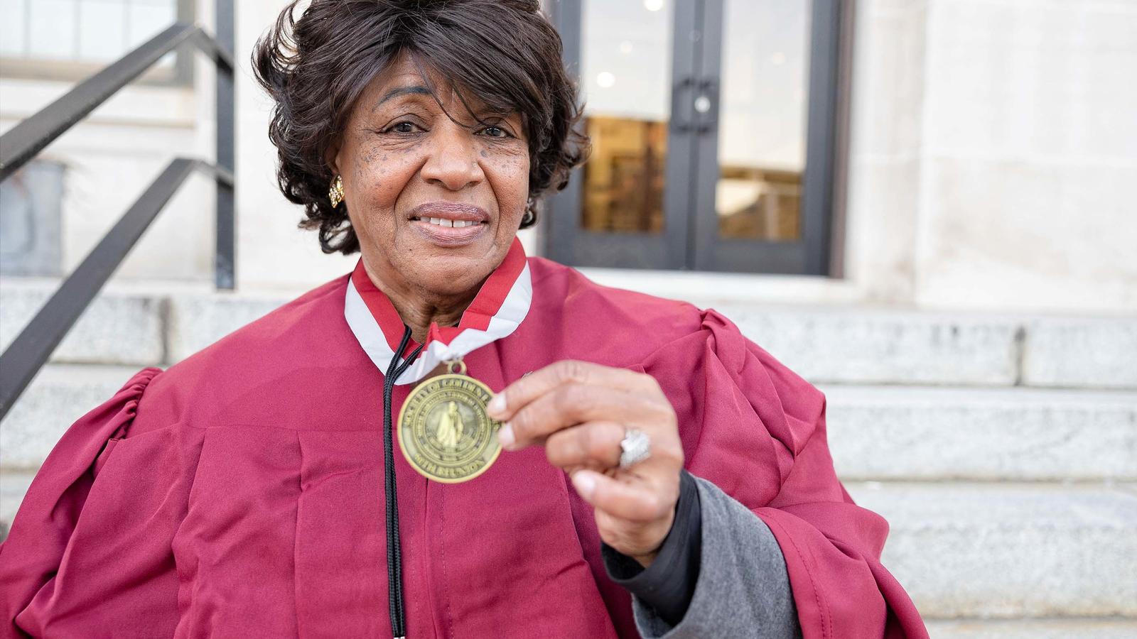 An image of a NCCU alum holding a medal