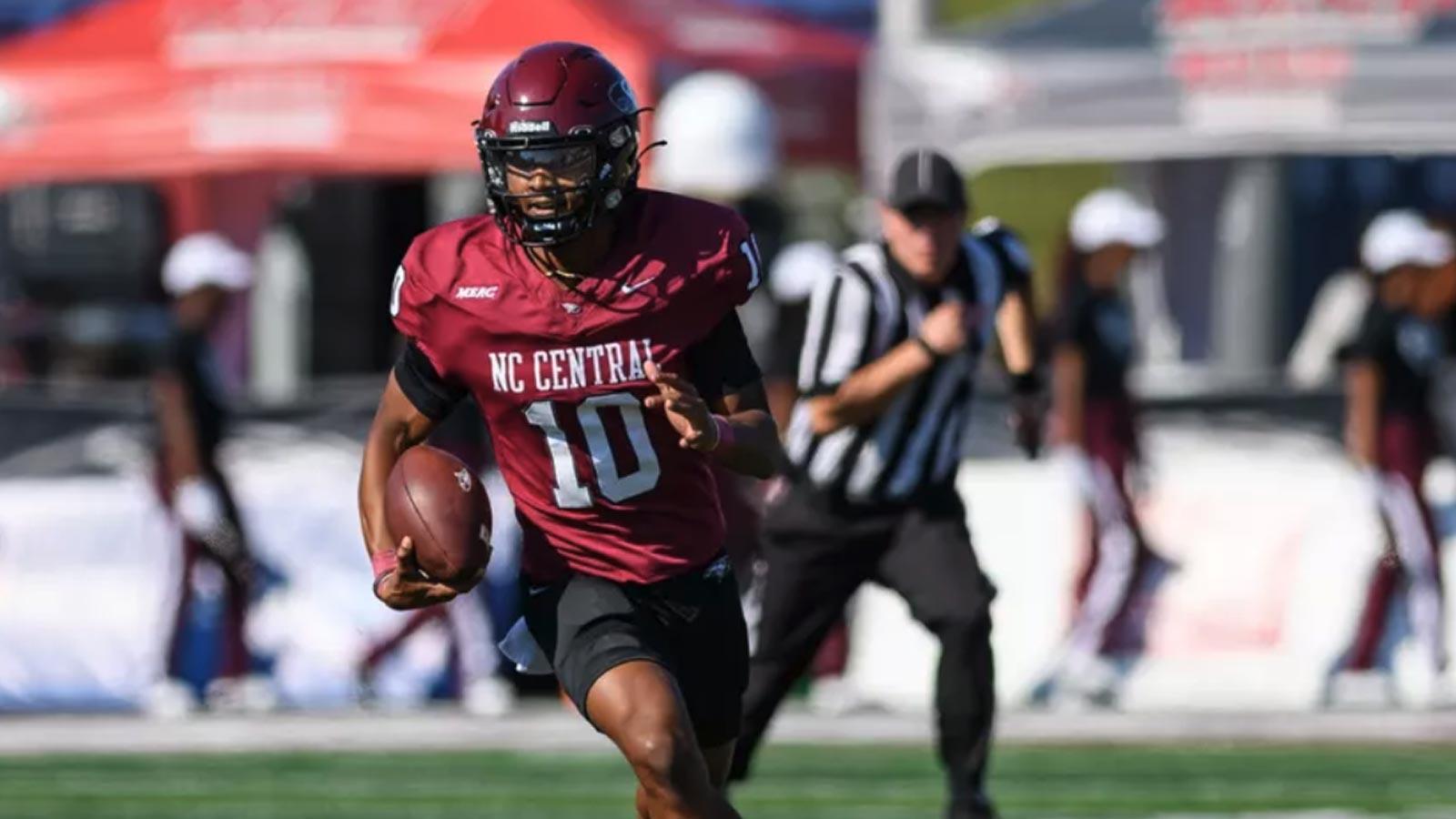 NCCU Football player running with football