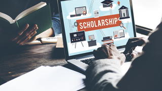 Person looking up scholarship information