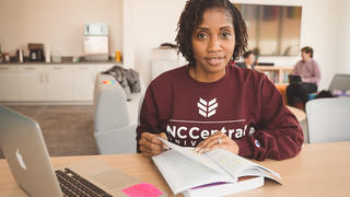 Student smiling with book