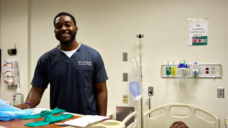 male nursing student with simulator patient