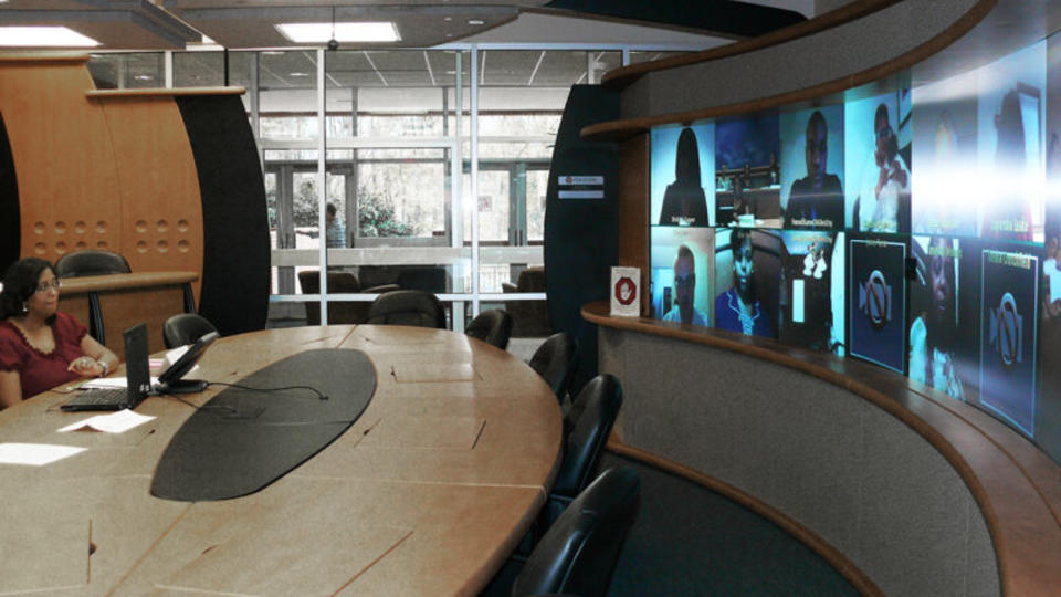 Person at a table conducting a Conference Call