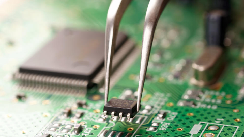 Image of a circuit board being assembled.