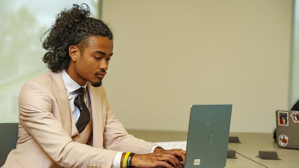 school of business student on laptop