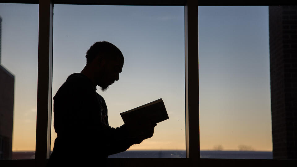 Student with book at dusk