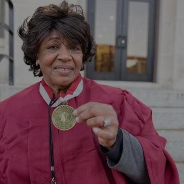 An image of a NCCU alum holding a medal